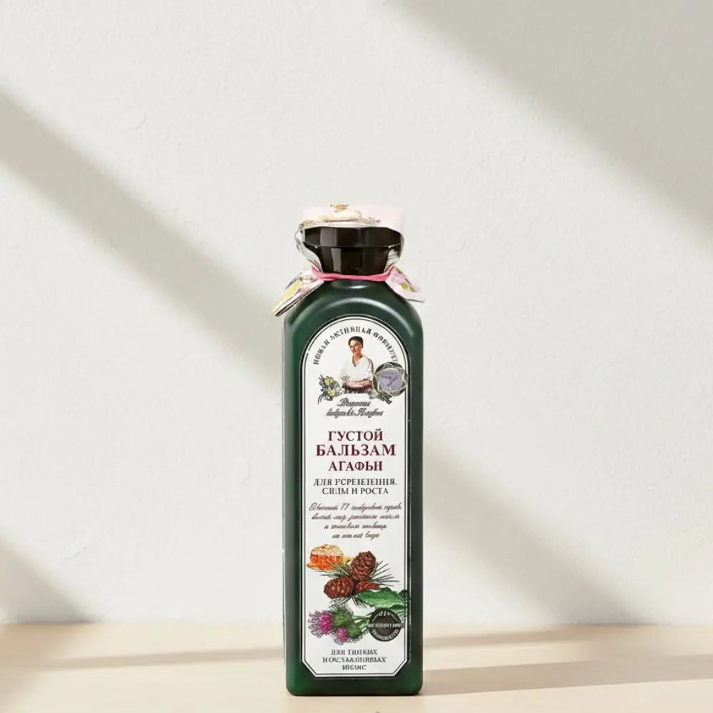 Bottle of balm with a label on a white background