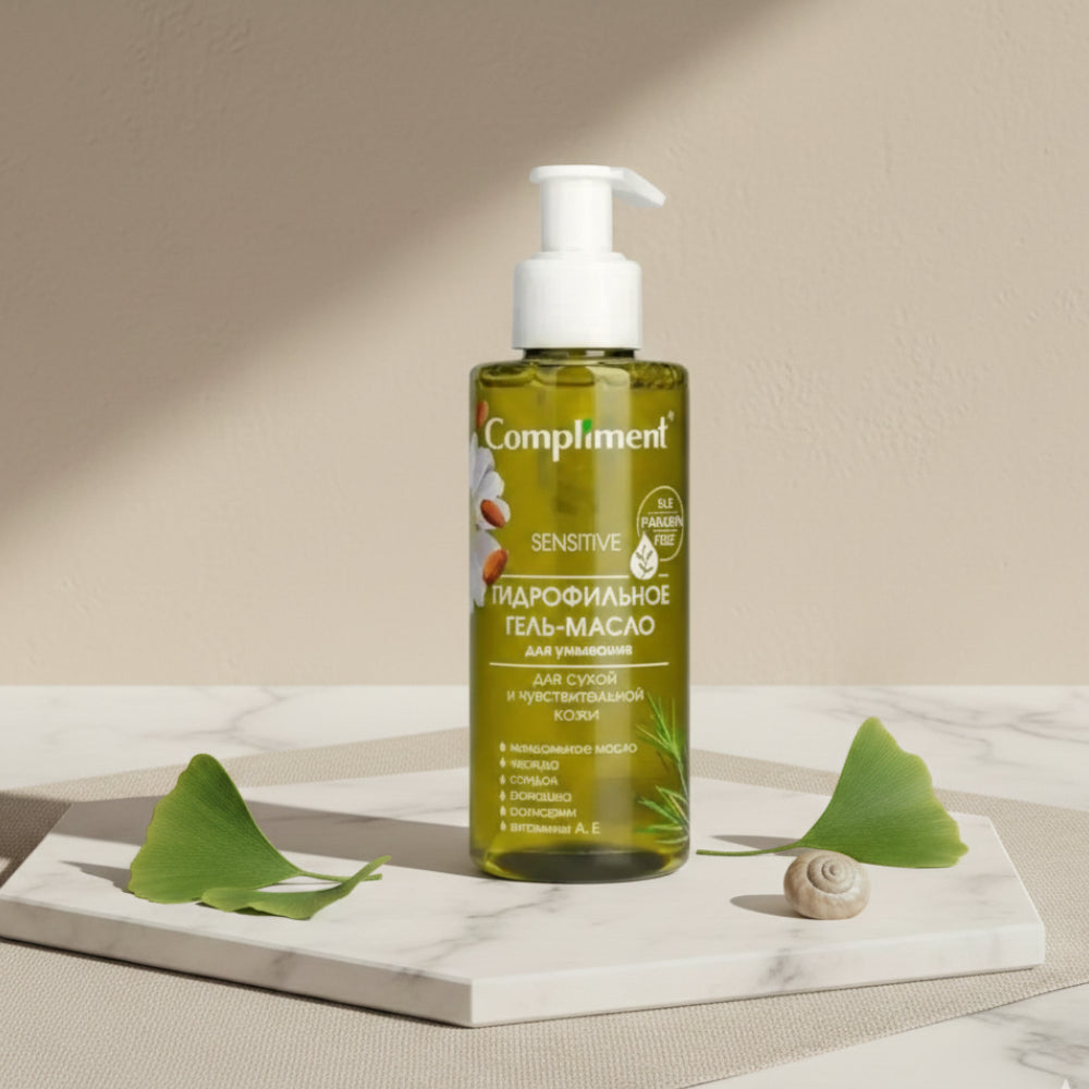 Bottle of Compliment sensitive skin care product on a neutral background with leaves and a shell.