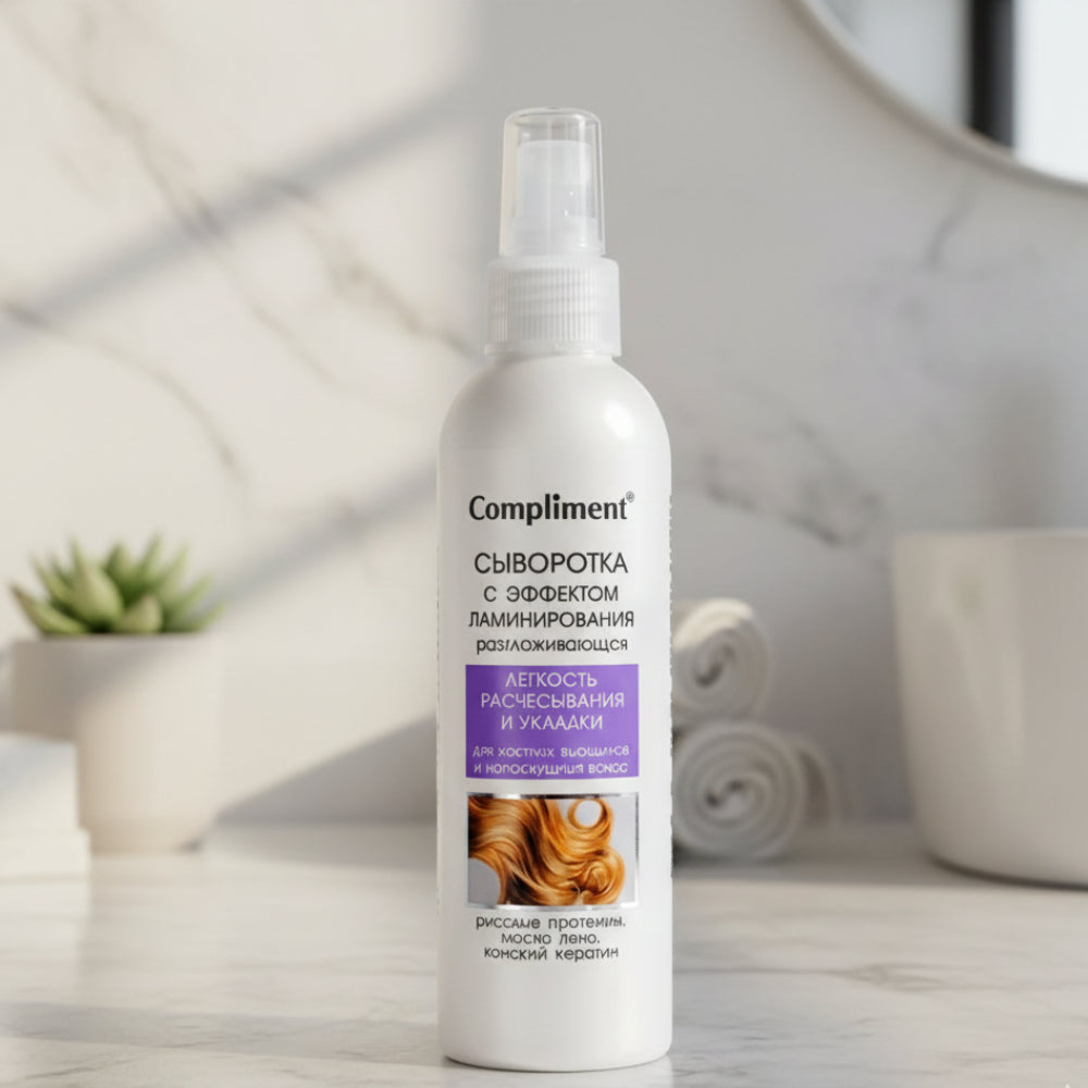 Compliment hair serum bottle on a table with a blurred background