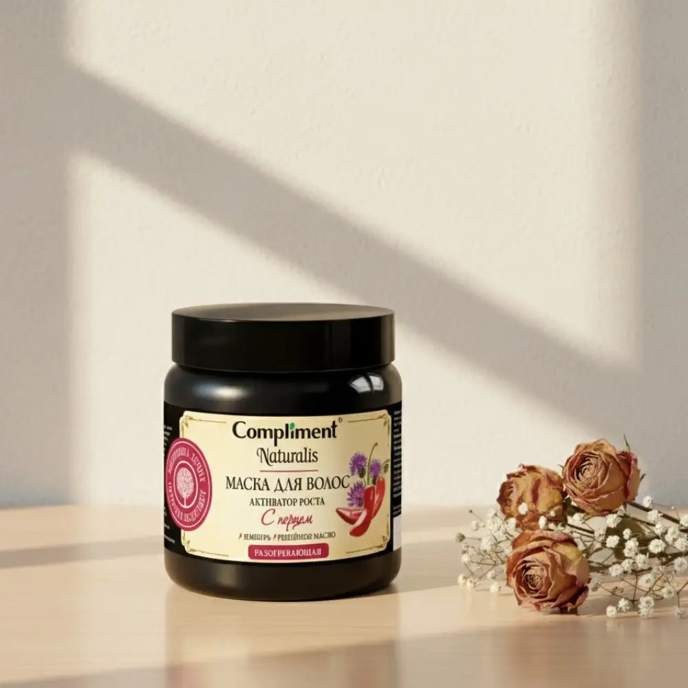 Black jar of 'Compliment' hair mask with a label on a white background