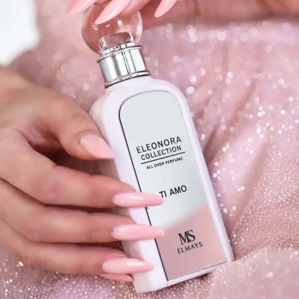 Woman holding a bottle of perfume with a plain background