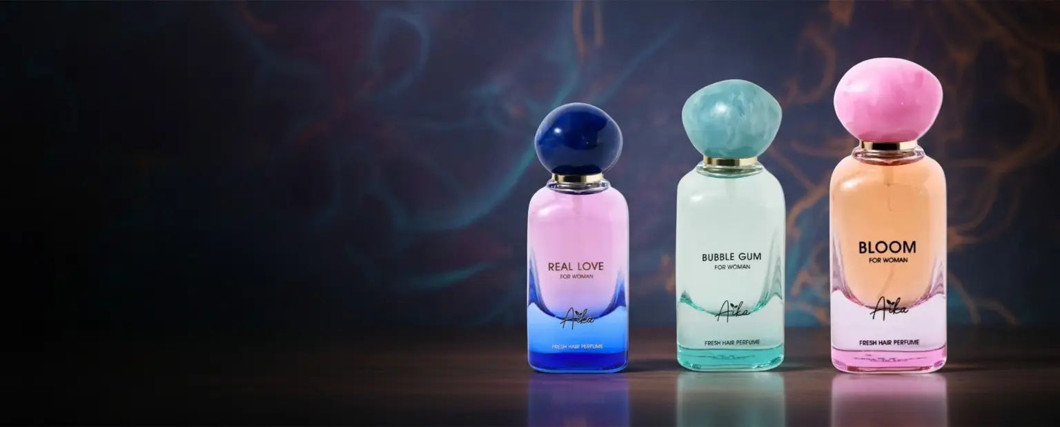 Three perfume bottles with colorful caps on a dark background